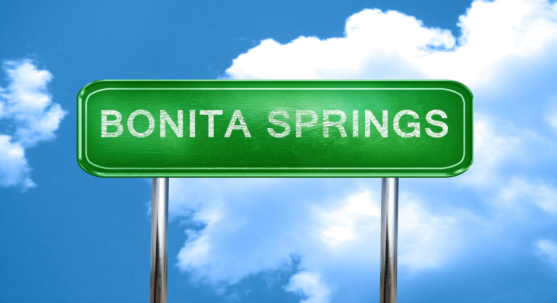 Bonita Springs road sign against a blue Florida sky