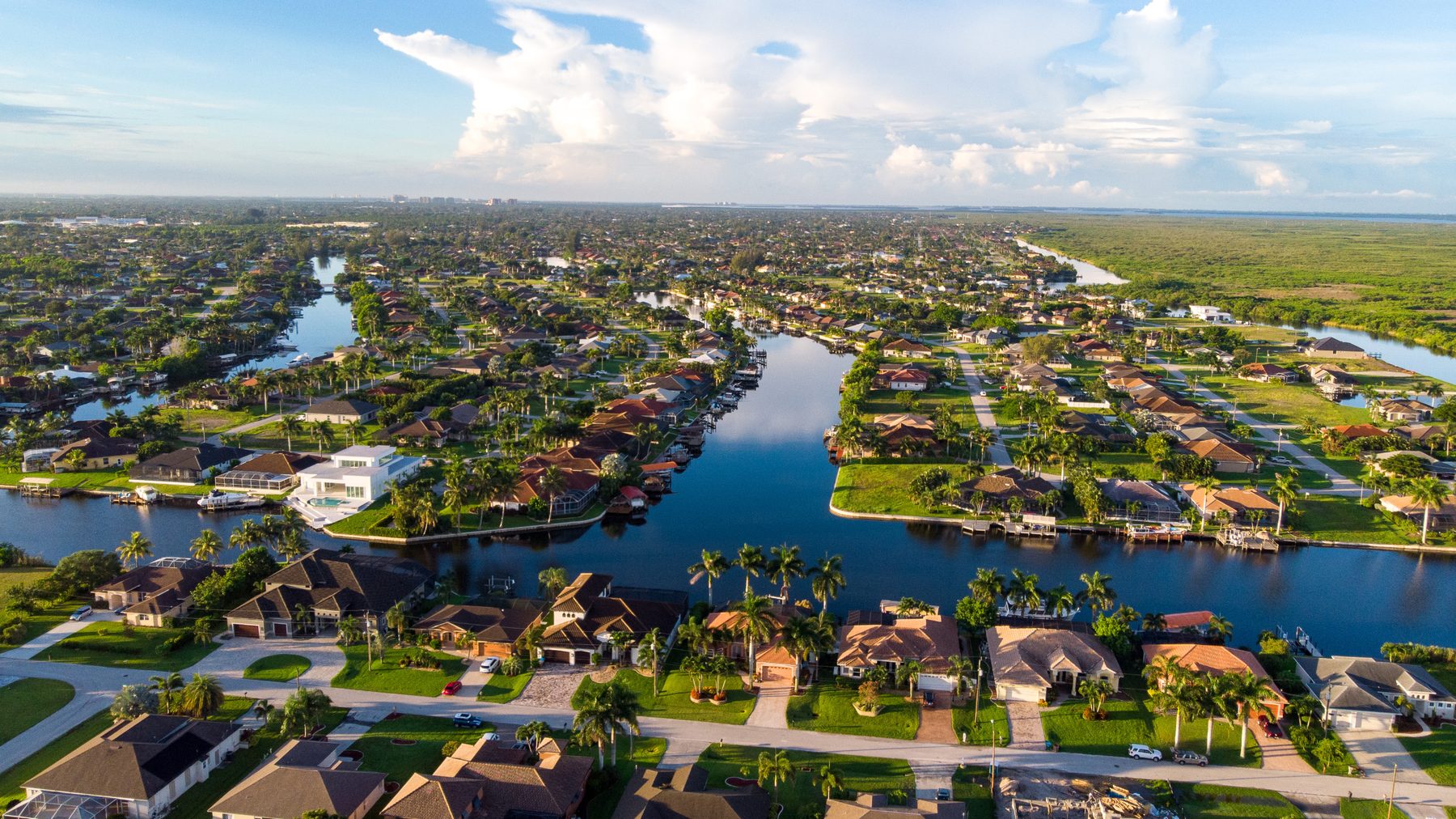 Aerial view of a Cape Coral canal neighborhood with boat docks