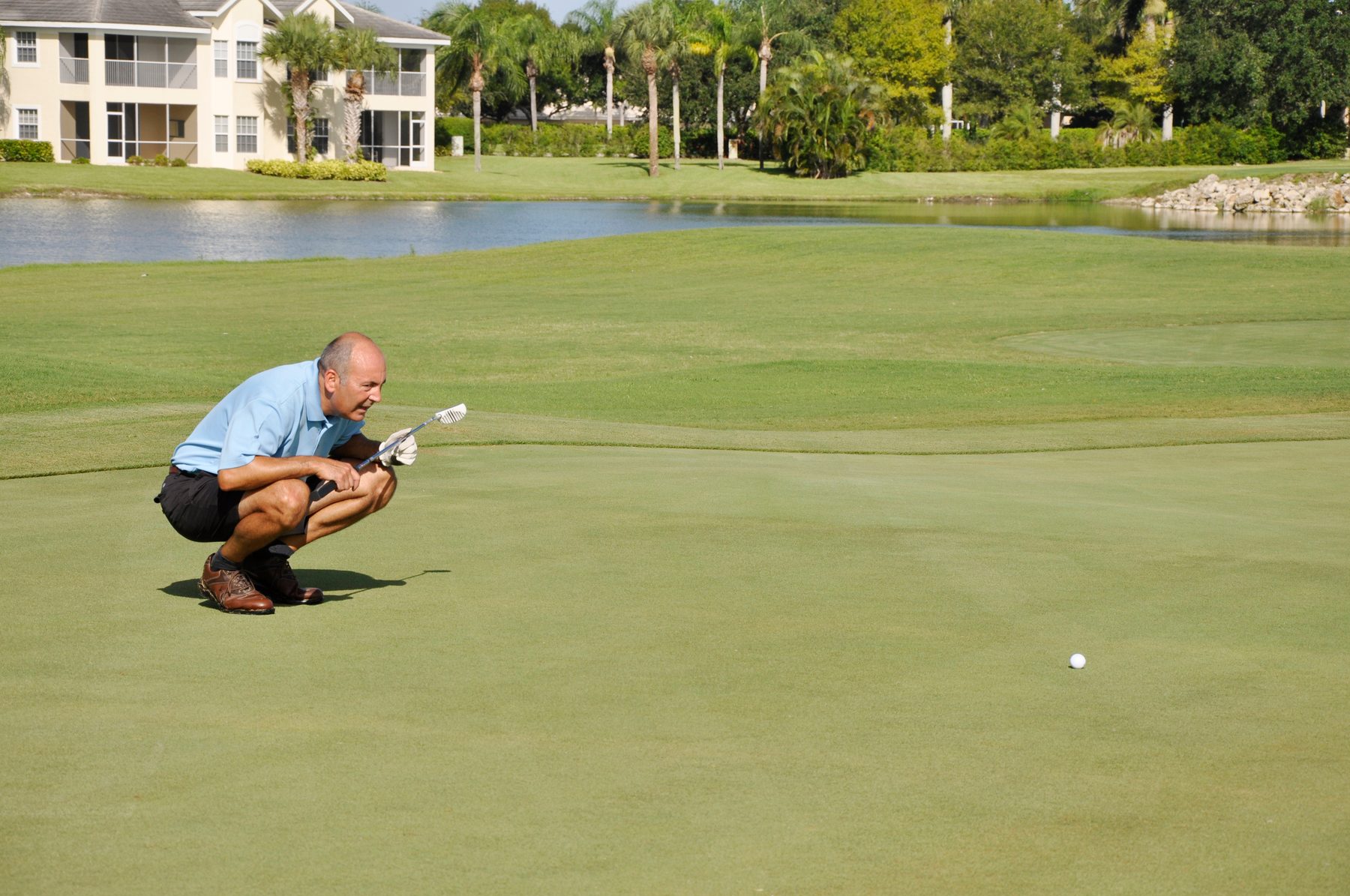 Golfer on a course green in a Southwest Florida gated golf community